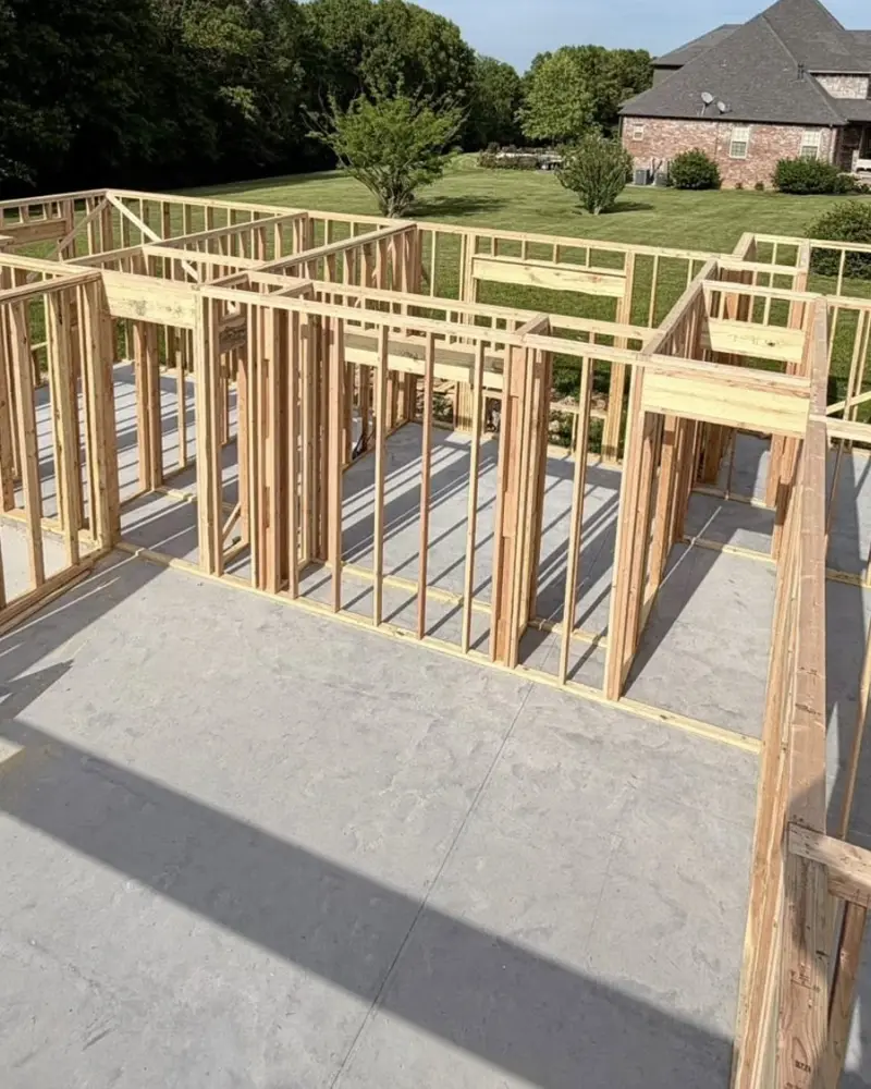 Framed walls standing on a new slab, built by the C&M Innovations framing crew
